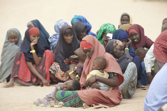1024px-Oxfam_East_Africa_-_New_arrivals_wait_to_get_processed